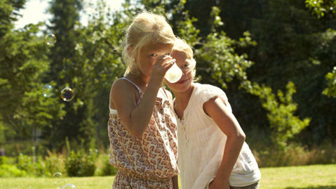 Two kids drinking milk